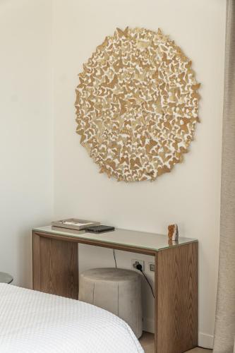 a bedroom with a desk with a bed and a mirror at Omana in Rocky Bay