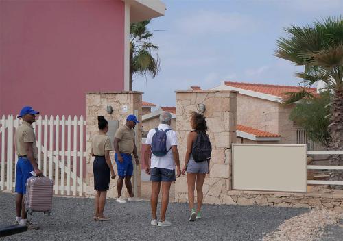 a group of people standing outside of a building at Appartamento Polvo. Stella Maris Exclusive in Calheta Do Maio