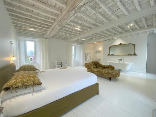a large bedroom with a large bed and a bathroom at Maison Galop Marin in Saint-Côme-du-Mont