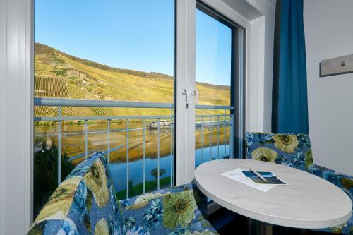 a room with a table and chairs and a large window at Sonnenuhr in Bernkastel-Kues