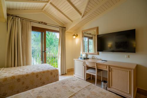 a bedroom with a bed and a desk with a mirror at Dalyan Resort - Special Category in Dalyan