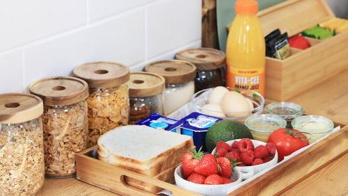 a tray of food with oats bread strawberries and eggs at Badger's View Farmstay GREEN HORNET Cabin in Railton