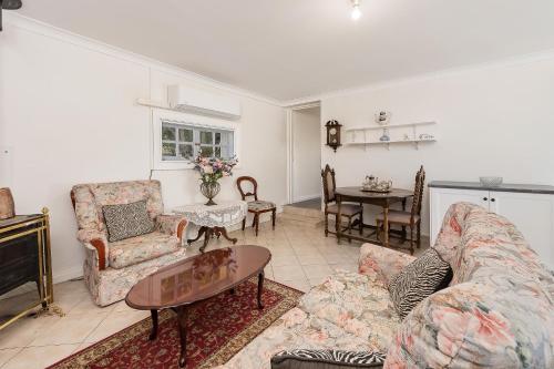 a living room with a couch and a table at Mt Barker Nina's 2BR Cottage in Mount Barker