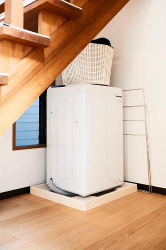 a microwave sitting on a shelf under a staircase at 1stop to Shibuya station Japanese traditional house in Tokyo
