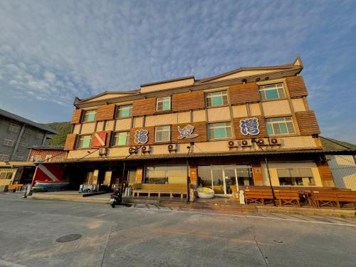 a large building with benches in front of it at 綠島海灣會館Bay Resort in Green Island