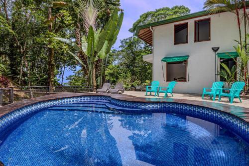 a swimming pool in front of a house at The Jungle Inn in Dominicalito