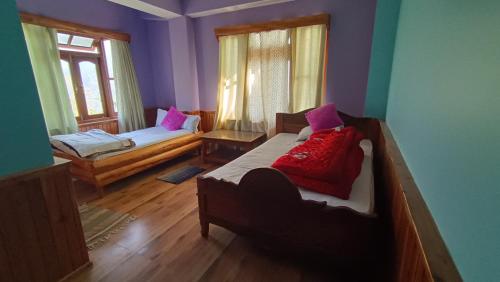 a bedroom with two beds and a window at Barbet Homestay Kitam in Namchi