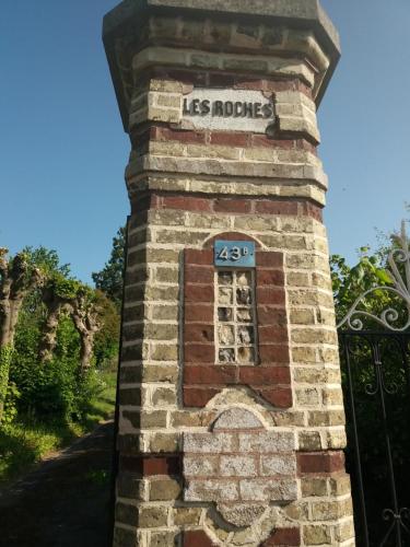 a brick clock tower with the words las morias on it at Les Roches in Bolbec