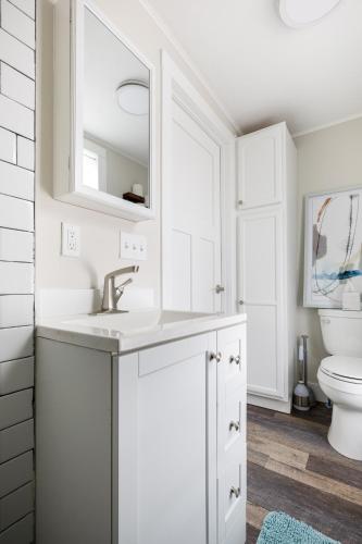 a white bathroom with a sink and a toilet at Modern Duplex Downtown AC Walkable in Traverse City