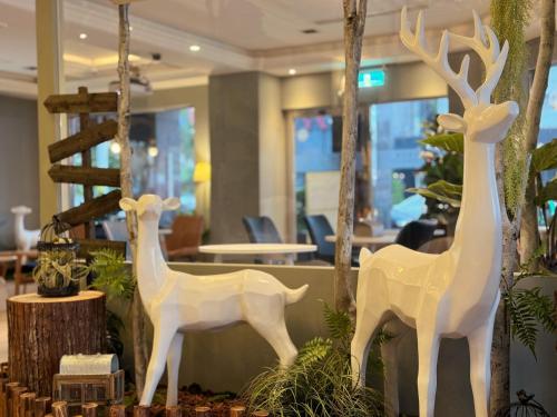 two white deers are on display in a lobby at Finders Hotel Hualien Station in Hualien City