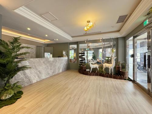 a lobby with a restaurant with a counter and a room with aitating at Finders Hotel Hualien Station in Hualien City