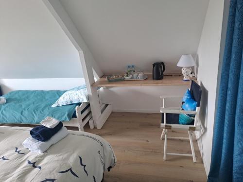 a bedroom with a desk and a bed and a desk and chair at Les grandes Masures B&B in Varengeville-sur-Mer