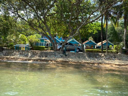 a body of water with houses in the background at Ban Tidlay - SHA in Ko Yao Noi