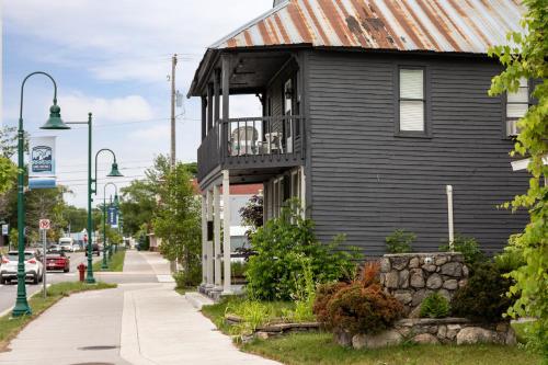 a black house with a balcony on a street at Juniper at Timberline Flats in Traverse City