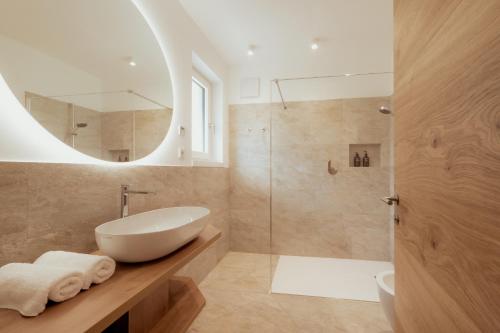a bathroom with a white sink and a shower at Gutshof Ebner in San Paolo