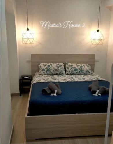 a bedroom with a bed with blue sheets and pillows at Mattia's house 2 in Bari