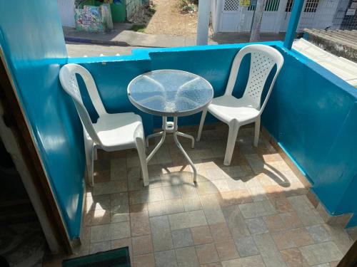 two chairs and a table and two tables and chairs at Miss Titi's Native Lodge in San Andrés