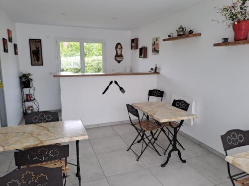 a dining room with a table and chairs at Les grandes Masures B&B in Varengeville-sur-Mer