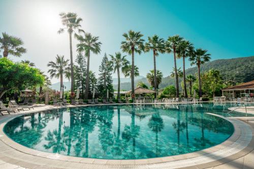 a pool at a resort with palm trees at Dalyan Resort - Special Category in Dalyan