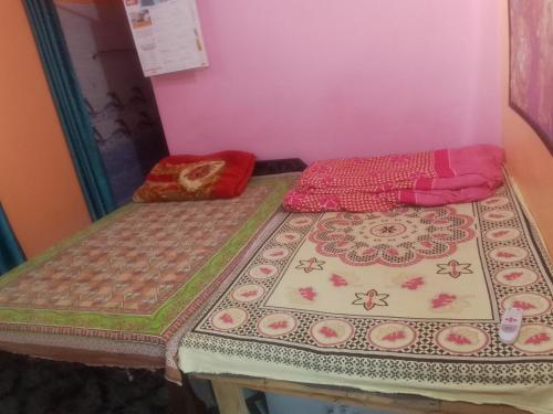 a bed with two pillows on it in a room at Bhatt Home Stay in Kishanpur