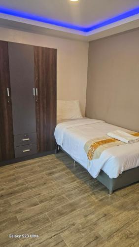 a bedroom with two beds and a blue ceiling at Central Guesthouse Chiang Rai - Bread & Breakfast in Chiang Rai