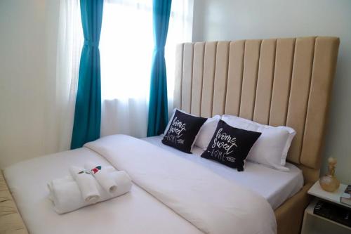 a bedroom with two beds with white sheets and pillows at Powerground Resort in Nairobi