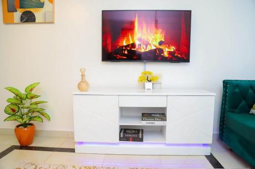 a living room with a tv above a fireplace at Powerground Resort in Nairobi