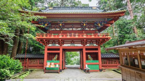 a temple in a park with a red building at Toyoko Inn Shizuoka eki Kita guchi in Shizuoka