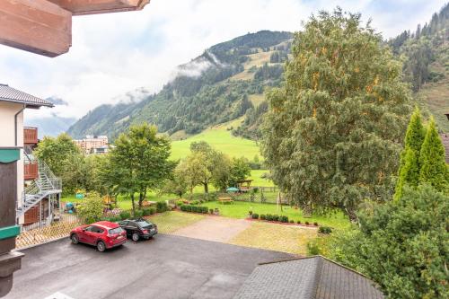 a view of a parking lot with two cars parked at Frühstückshotel Birkenhof in Rauris