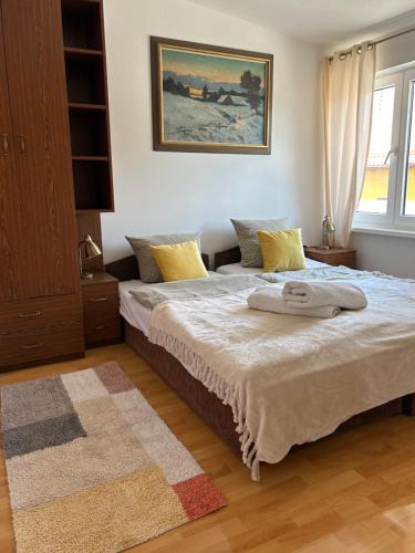 a bedroom with two beds with towels on it at Gościniec Pod Lipą in Mikołajki