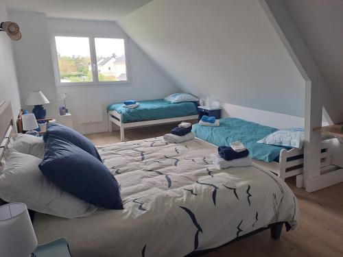 a bedroom with a large bed with blue pillows at Les grandes Masures B&B in Varengeville-sur-Mer