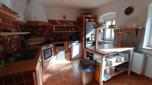 a kitchen with a table and a counter top at Penzion Stříbrný vítr in Horní Planá