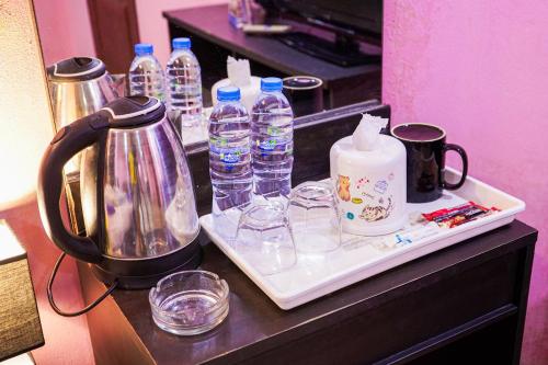 a counter with bottles of water and glasses on it at Marine paradise Encore in Pattaya South