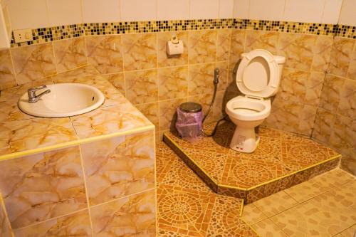a bathroom with a toilet and a sink at Marine paradise Encore in Pattaya South