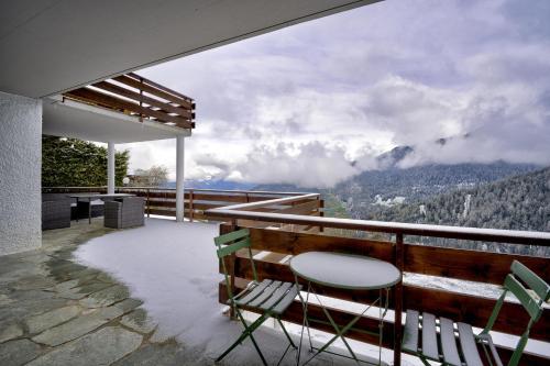 a balcony of a house with a view of the mountains at Chalet Coeur in La Tzoumaz