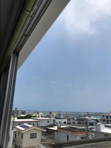 a view of a city from a window at アワセベイストリートホテル in Okinawa City