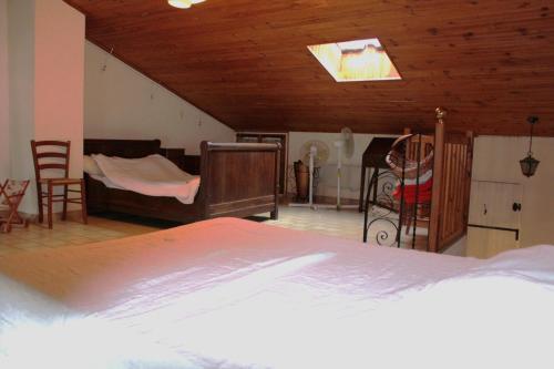 une chambre avec un lit et des chaises dans une pièce dans l'établissement Maison de Village, à Entrechaux