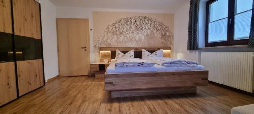 a bedroom with a large bed with white pillows at Haus Kirchmaier in Pertisau