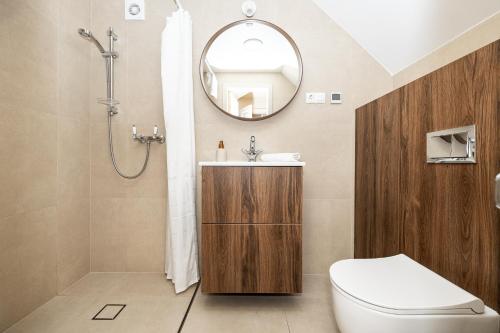 a bathroom with a toilet and a sink and a mirror at Studio@NidosBanga, By Cohost in Nida