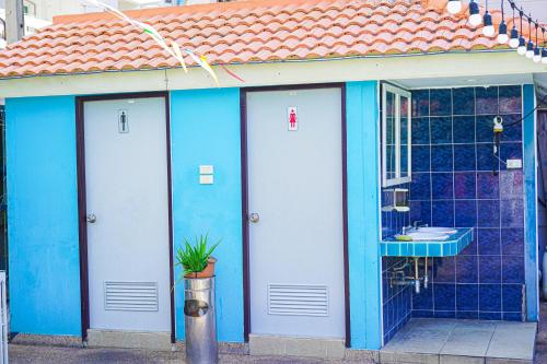 a blue building with a bathroom with a sink at Marine paradise Encore in Pattaya South