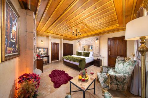 a living room with a bed and a couch at Cappadocia Pegasos Cave Suite Hotel in Uçhisar