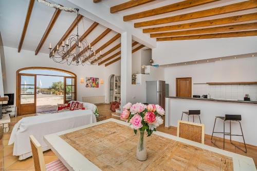 a living room with a vase of flowers on a table at Finca Puig Blanc by Sealand Villas in Muro