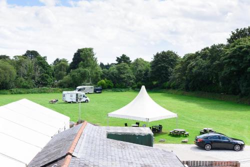 a car parked in a field with white tents at The Britannia Inn & Waves Restaurant in St Austell