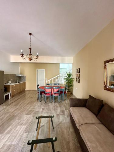 a living room with a couch and a table at Nautica Hotel Apartments in Stavromenos