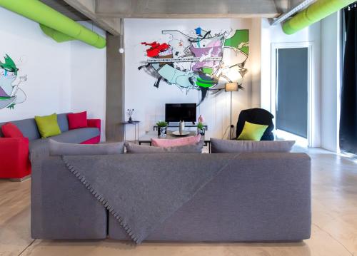 a living room with a couch and a tv at Ceramus Apartments Gazi View in Athens