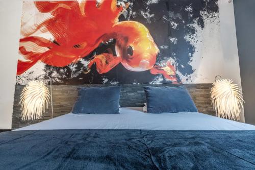 a bedroom with a bed with a painting on the wall at Hôtel Quai des Pontis in Cognac