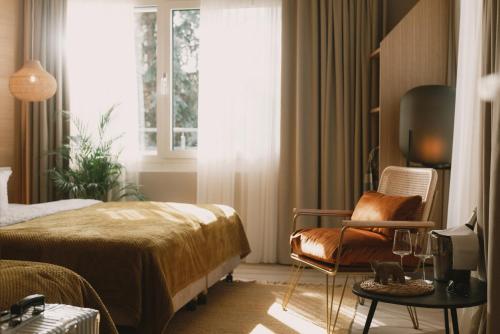 a bedroom with a bed and a chair and a window at 2Places Soul in Lörrach
