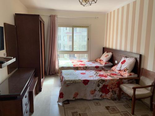 a hotel room with two beds and a window at 5 stars Studio Aqua View North coast in Borg El Arab