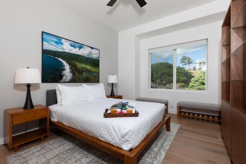 a white bedroom with a bed and a window at SUN RAY RETREAT Ocean Sunsets Views Optional Mauna Kea Hotel Privileges in Waimea
