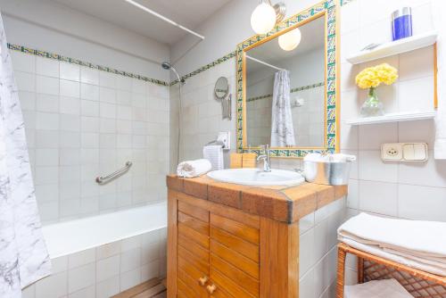 a bathroom with a sink and a tub at Casa S'Olivaret -Selva- in El Port de la Selva